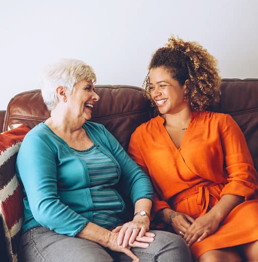 woman and senior woman smiling