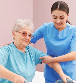 woman helping senior woman stand up