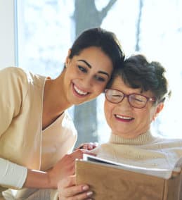woman and senior woman reading