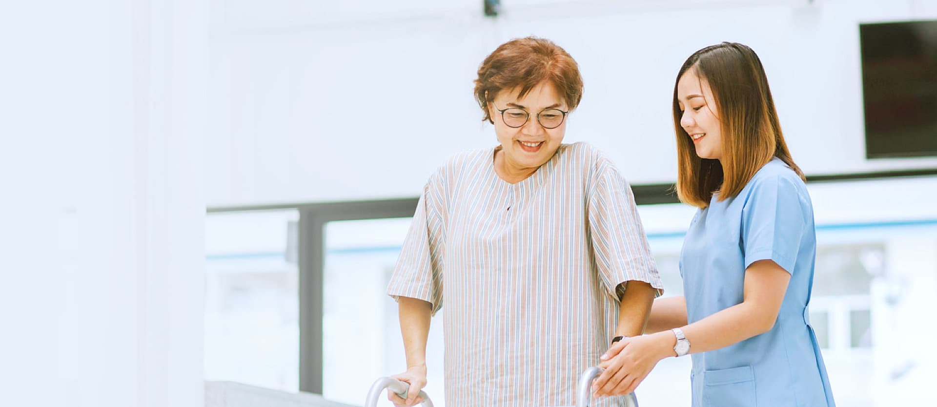 woman helping senior woman walk around