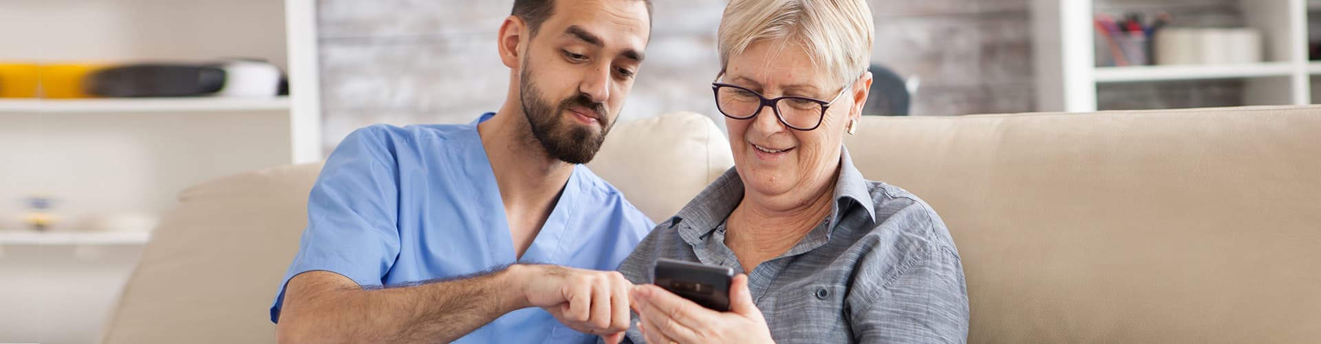 man and senior woman looking at the phone